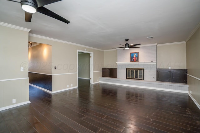 3408 Hawthorne Dr, Amarillo, TX 79109 - unfurnished living room with ceiling fan, a fireplace, wood finished floors, wainscoting, and crown molding