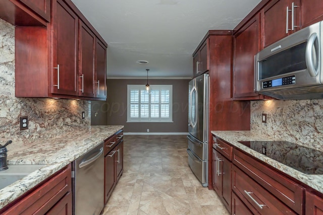3408 Hawthorne Dr, Amarillo, TX 79109 - kitchen featuring stainless steel appliances, dark brown cabinets, crown molding, baseboards, and light stone countertops