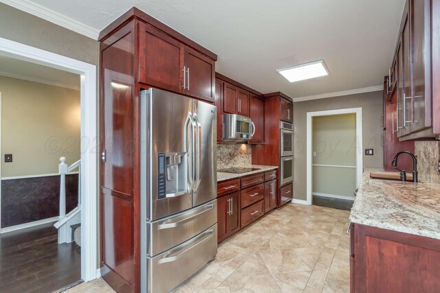 3408 Hawthorne Dr, Amarillo, TX 79109 - kitchen with stainless steel appliances, a sink, decorative backsplash, light stone countertops, and reddish brown cabinets
