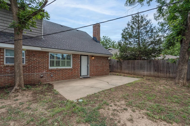 3408 Hawthorne Dr, Amarillo, TX 79109 - rear view of house with a shingled roof, fence, and a patio area