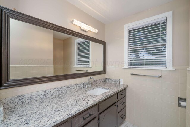 3408 Hawthorne Dr, Amarillo, TX 79109 - bathroom featuring vanity and tile walls