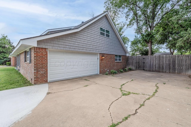 3408 Hawthorne Dr, Amarillo, TX 79109 - view of side of property with brick siding, a garage, fence, and driveway