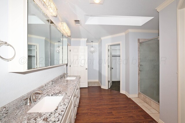 7501 Countryside Dr, Amarillo, TX 79119 - full bath with a shower stall, ornamental molding, double vanity, and wood finished floors