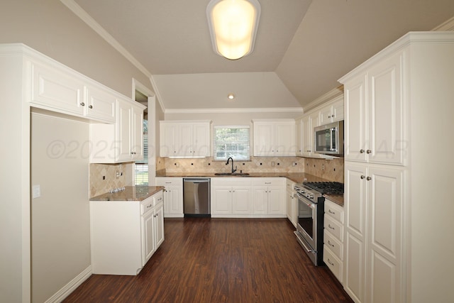7501 Countryside Dr, Amarillo, TX 79119 - kitchen featuring appliances with stainless steel finishes, a sink, dark wood-type flooring, white cabinetry, and decorative backsplash