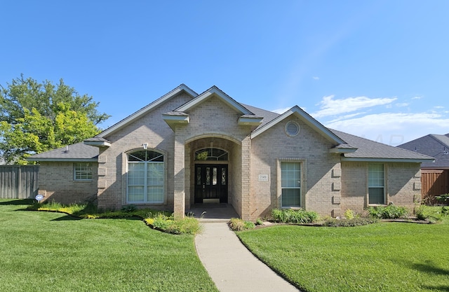 7501 Countryside Dr, Amarillo, TX 79119 - view of front of home featuring brick siding, french doors, and roof with shingles