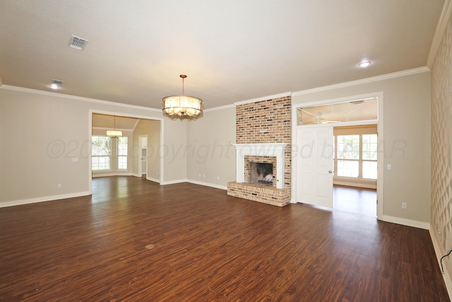 7501 Countryside Dr, Amarillo, TX 79119 - unfurnished living room featuring a chandelier, baseboards, dark wood-type flooring, a fireplace, and crown molding