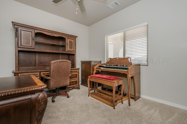 office space featuring a ceiling fan, light carpet, visible vents, and baseboards