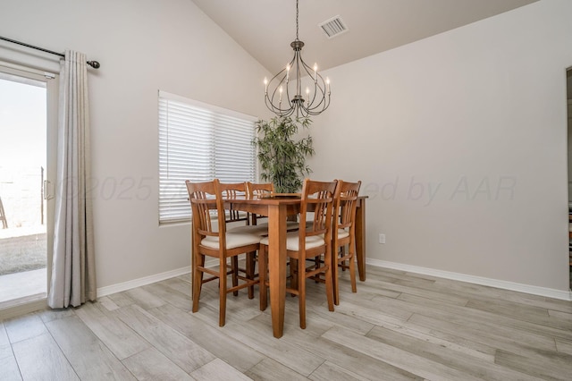 dining area featuring a chandelier, light wood-type flooring, visible vents, and lofted ceiling