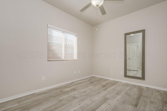 empty room featuring light wood finished floors, baseboards, and a ceiling fan