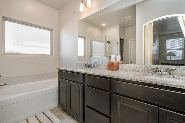 full bath featuring a garden tub, a sink, visible vents, and a shower stall