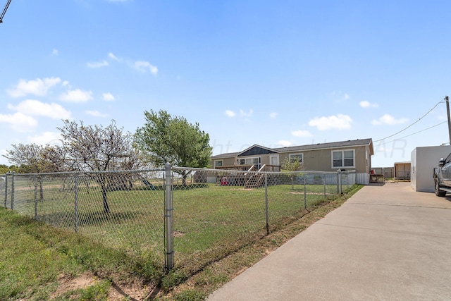 view of front of property featuring fence, a front yard, and concrete driveway