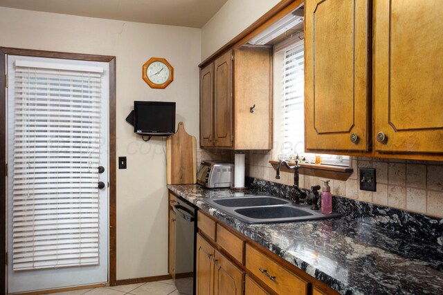 8219 Lamount Dr, Amarillo, TX 79110 - kitchen featuring dishwashing machine, brown cabinets, and light tile patterned floors