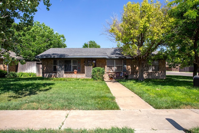 8219 Lamount Dr, Amarillo, TX 79110 - ranch-style house with brick siding and a front lawn