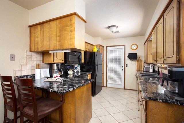 8219 Lamount Dr, Amarillo, TX 79110 - kitchen with black appliances, brown cabinetry, a peninsula, backsplash, and light tile patterned flooring