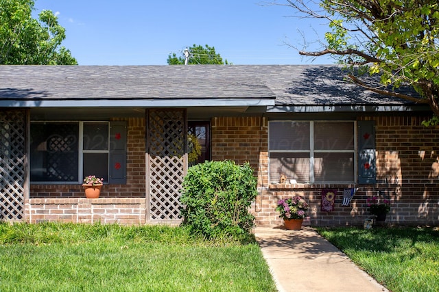 8219 Lamount Dr, Amarillo, TX 79110 - entrance to property with brick siding, a shingled roof, and a yard