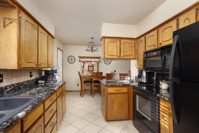 8219 Lamount Dr, Amarillo, TX 79110 - kitchen with black appliances, brown cabinets, a peninsula, and tasteful backsplash
