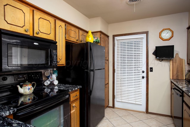 8219 Lamount Dr, Amarillo, TX 79110 - kitchen featuring black appliances, brown cabinets, and light tile patterned flooring
