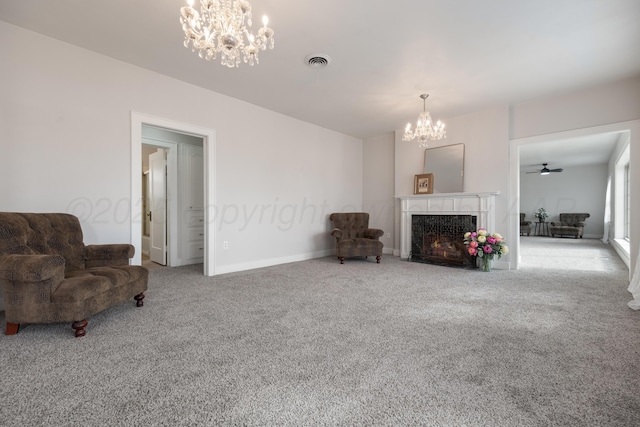 living room featuring a high end fireplace, light carpet, and a chandelier