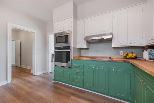 kitchen with wood counters, light hardwood / wood-style flooring, stainless steel appliances, and white cabinets