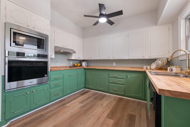 kitchen featuring sink, white cabinetry, wooden counters, appliances with stainless steel finishes, and dark hardwood / wood-style flooring