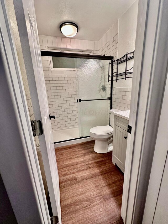 1214 S Alabama St, Amarillo, TX 79102 - full bathroom featuring wood finished floors, a stall shower, and vanity