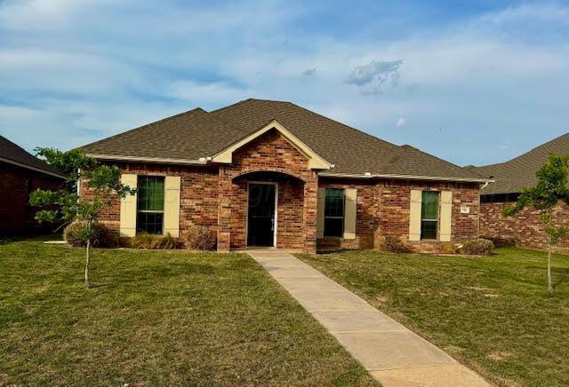 7901 Crestline Dr, Amarillo, TX 79119 - view of front facade featuring a front lawn, brick siding, and roof with shingles