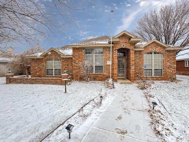 ranch-style home featuring brick siding