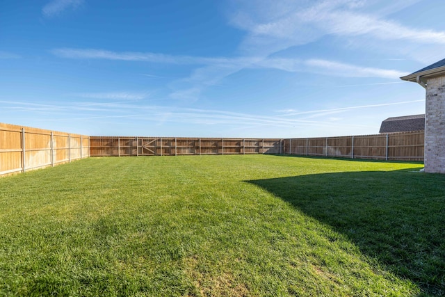 view of yard with a fenced backyard