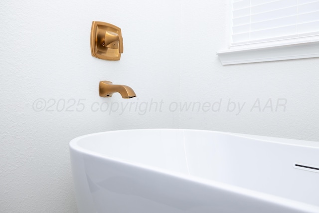 bathroom with a soaking tub