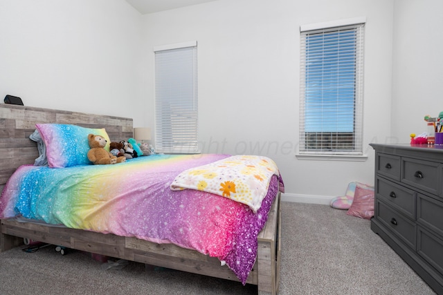 bedroom with baseboards and carpet