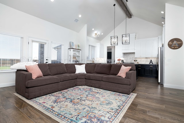 living room with high vaulted ceiling, a wealth of natural light, visible vents, and beamed ceiling