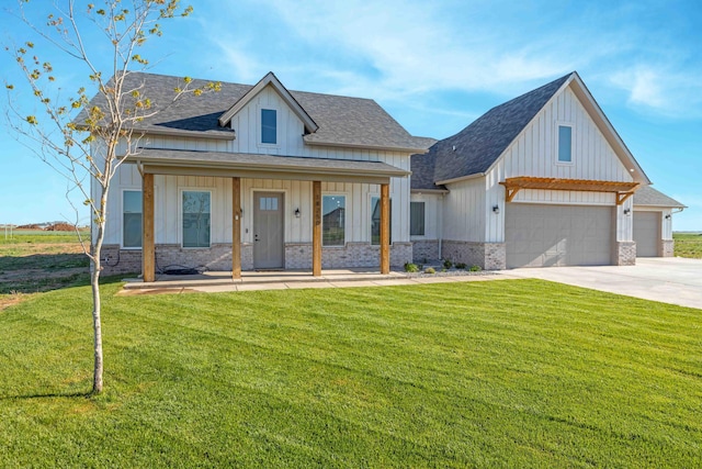 view of front of home with board and batten siding, driveway, a shingled roof, and a front lawn