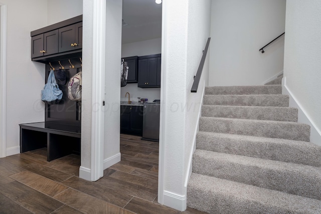 stairway with wood finished floors and baseboards