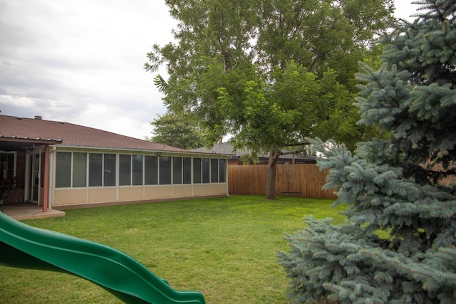 1403 Charles Ave, Panhandle, TX 79068 - view of yard featuring a playground and a sunroom