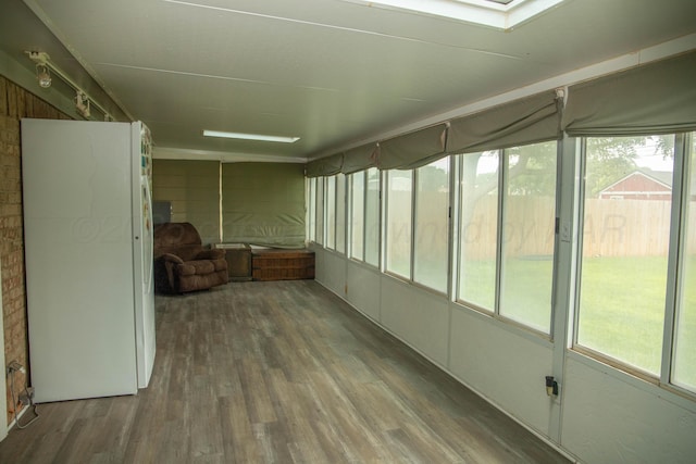 1403 Charles Ave, Panhandle, TX 79068 - unfurnished sunroom featuring wood finished floors