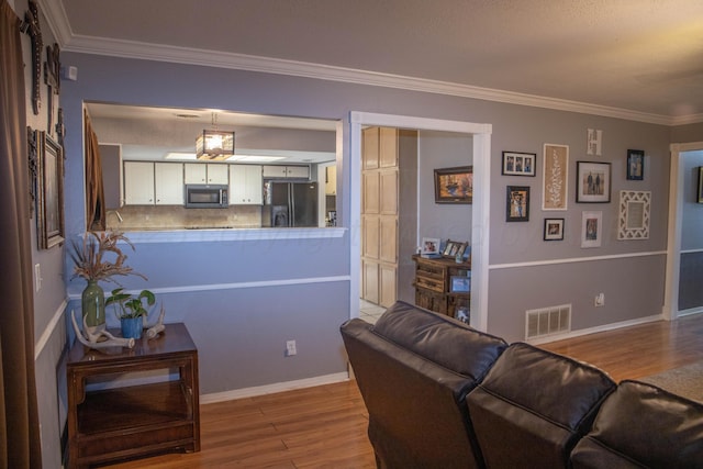1403 Charles Ave, Panhandle, TX 79068 - living area featuring wood finished floors and ornamental molding