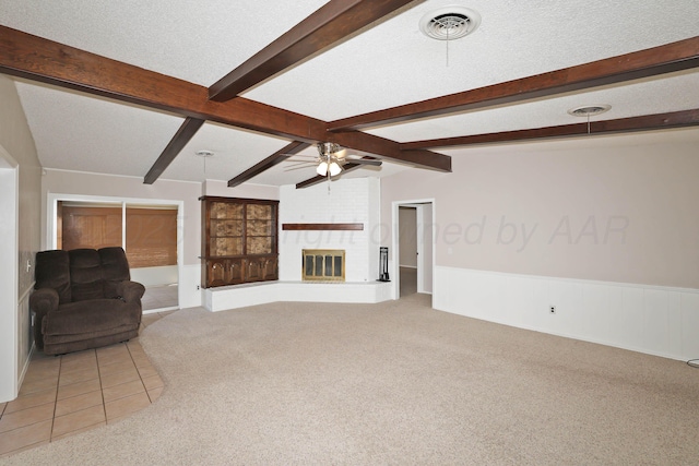 3519 Rutson Dr, Amarillo, TX 79109 - living area with light carpet, ceiling fan, beamed ceiling, wainscoting, and a fireplace