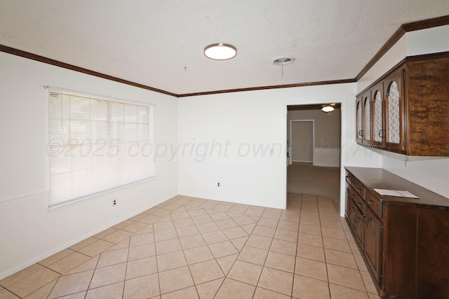 3519 Rutson Dr, Amarillo, TX 79109 - kitchen featuring ornamental molding, plenty of natural light, dark brown cabinets, and dark countertops