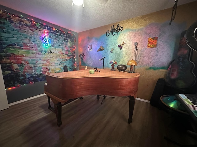 miscellaneous room with wood-type flooring and a textured ceiling