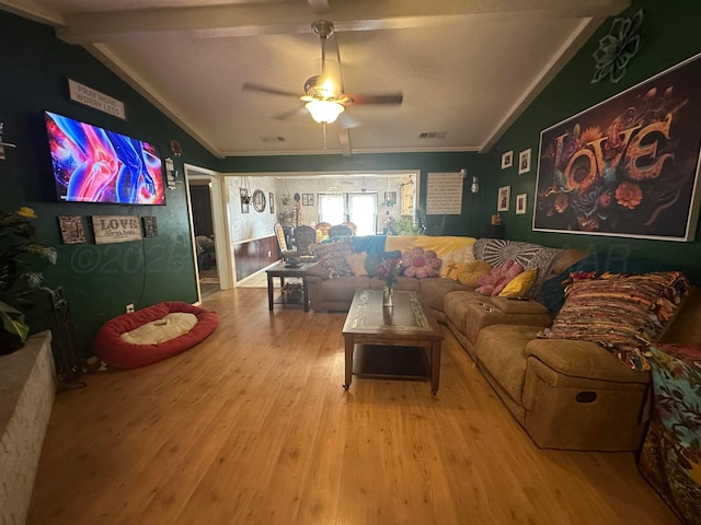 living room featuring hardwood / wood-style floors, crown molding, lofted ceiling with beams, and ceiling fan