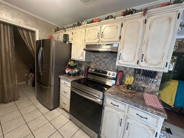 kitchen with light tile patterned floors, stainless steel appliances, ornamental molding, decorative backsplash, and dark stone counters