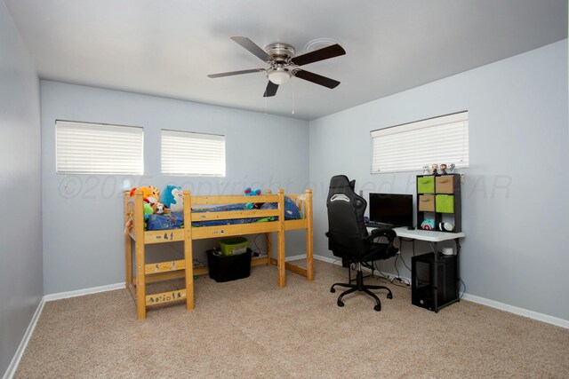 5506 Everett Ave, Amarillo, TX 79106 - bedroom with carpet floors, a desk, and a ceiling fan