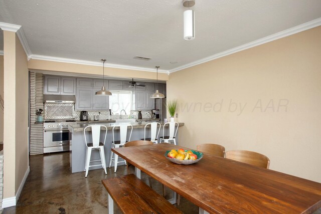 5506 Everett Ave, Amarillo, TX 79106 - dining room with ornamental molding and concrete floors
