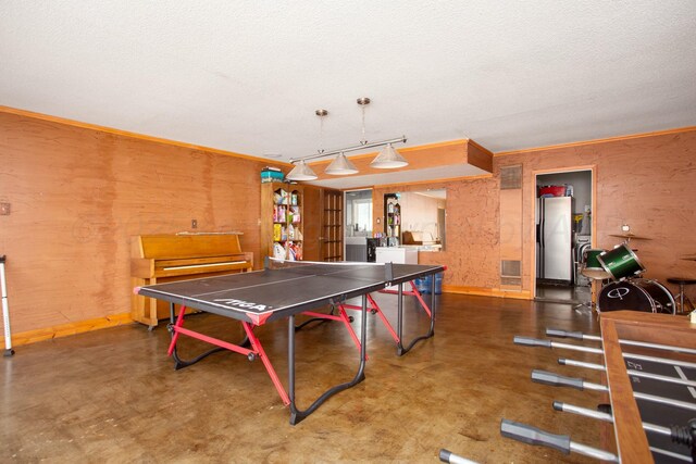 5506 Everett Ave, Amarillo, TX 79106 - rec room featuring a textured ceiling, concrete floors, and washer / clothes dryer