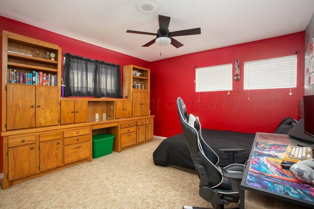 5506 Everett Ave, Amarillo, TX 79106 - bedroom with a desk, light colored carpet, and a ceiling fan