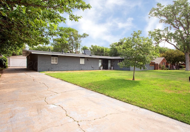 5506 Everett Ave, Amarillo, TX 79106 - view of front of home featuring a front yard, brick siding, concrete driveway, and a chimney