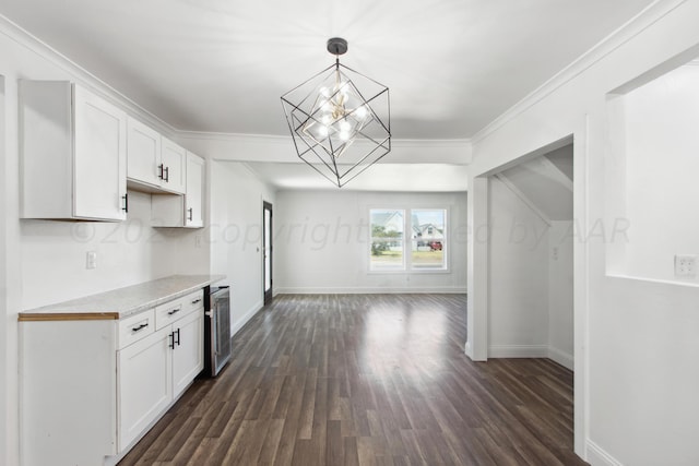 kitchen with beverage cooler, hanging light fixtures, ornamental molding, dark hardwood / wood-style floors, and white cabinetry