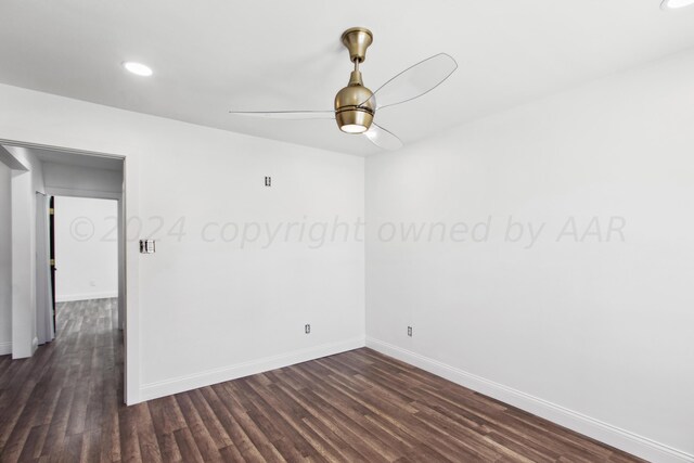 empty room featuring dark hardwood / wood-style flooring and ceiling fan