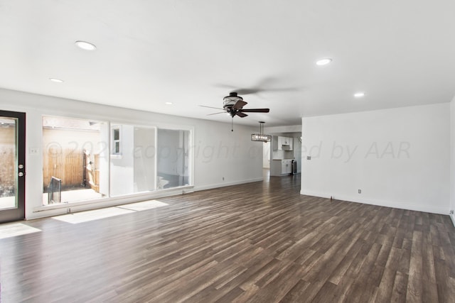 unfurnished living room with ceiling fan and dark hardwood / wood-style floors