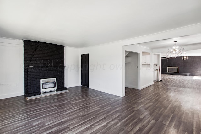 unfurnished living room featuring heating unit, dark hardwood / wood-style floors, and crown molding